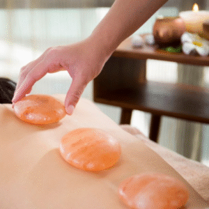 Himalayan salt stone therapy massage add-on at iOnyx Medspa Merritt Island for detox, circulation, and deep relaxation